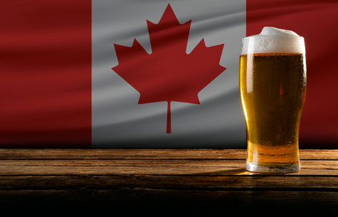 Glass of beer in front of Canadian flag