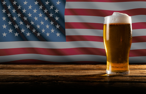Glass of beer in front of American flag